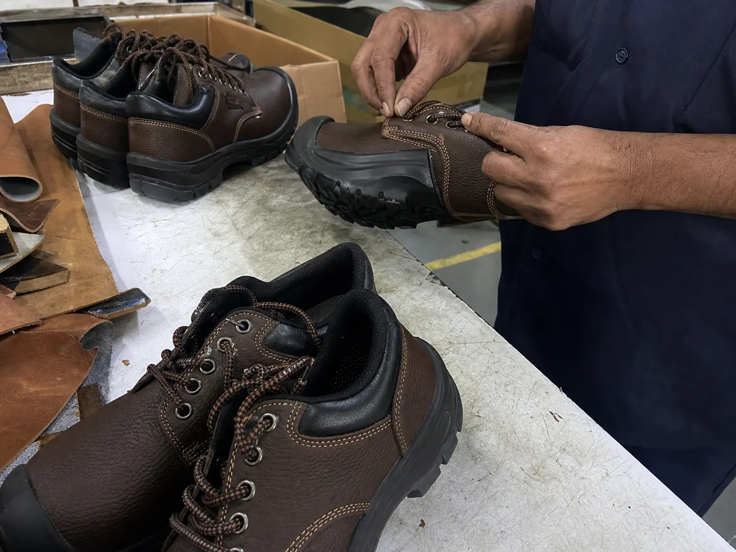 Raw mobile photo of safety shoes being inspected in factory