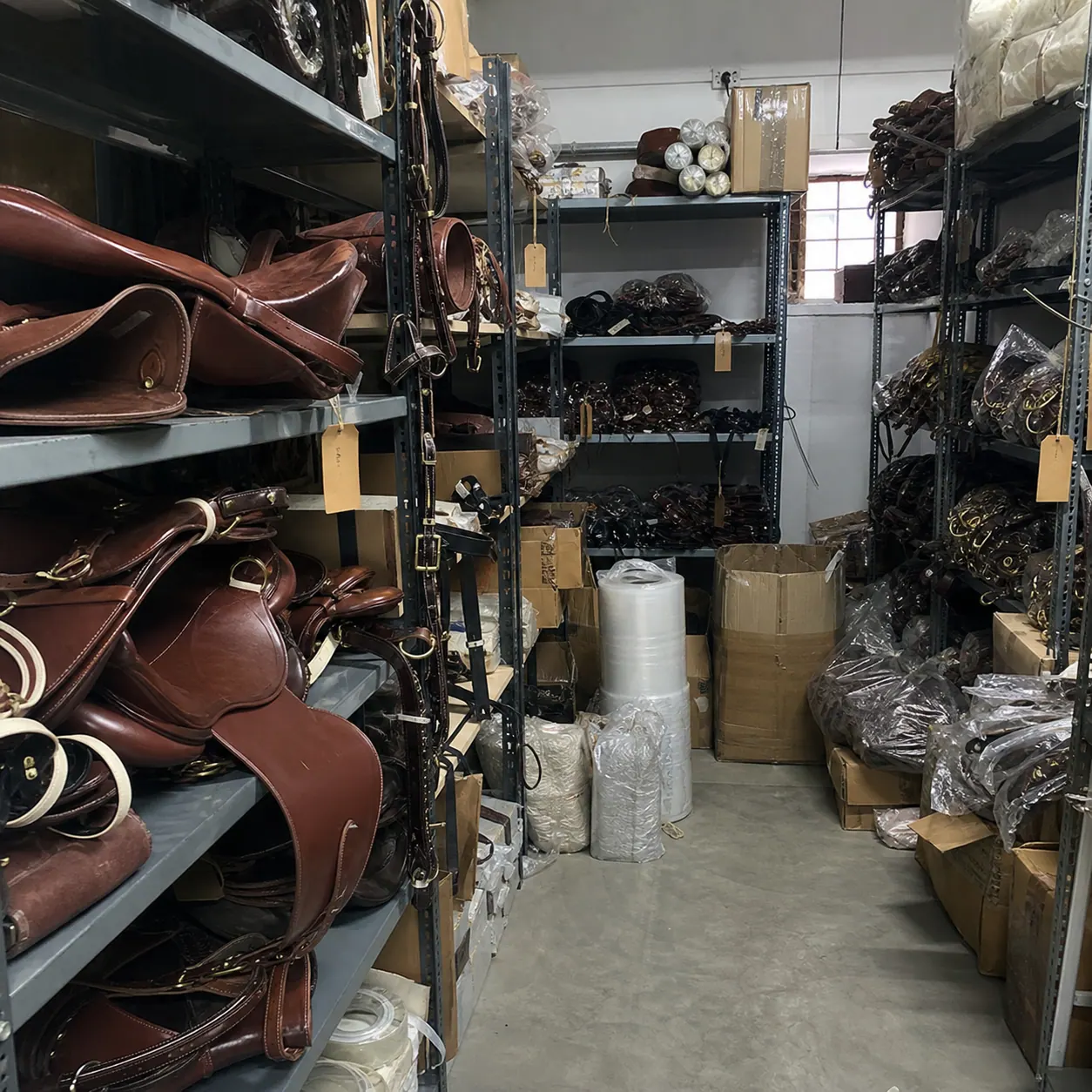 Raw mobile photo of saddlery stock room with leather goods