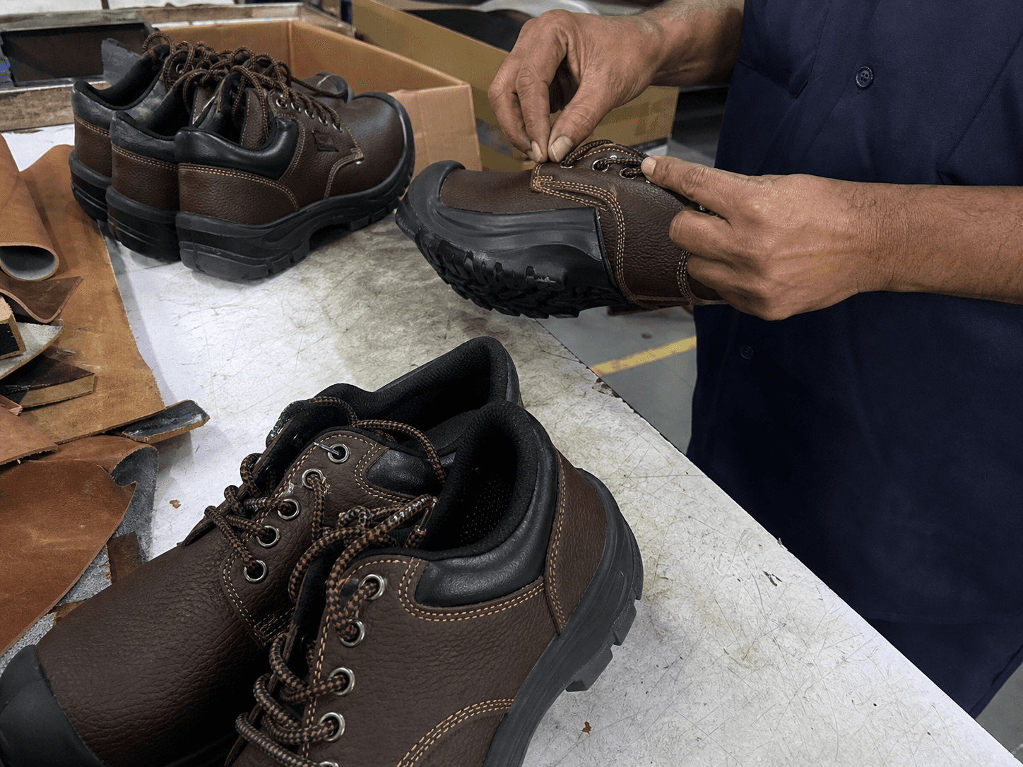 Raw mobile photo of safety shoes being inspected in factory